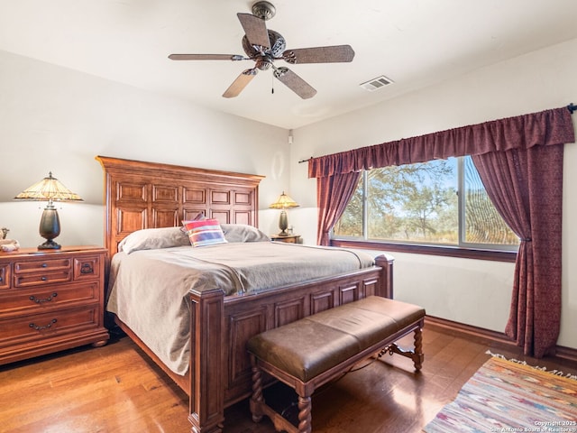 bedroom featuring light wood-type flooring, visible vents, and ceiling fan