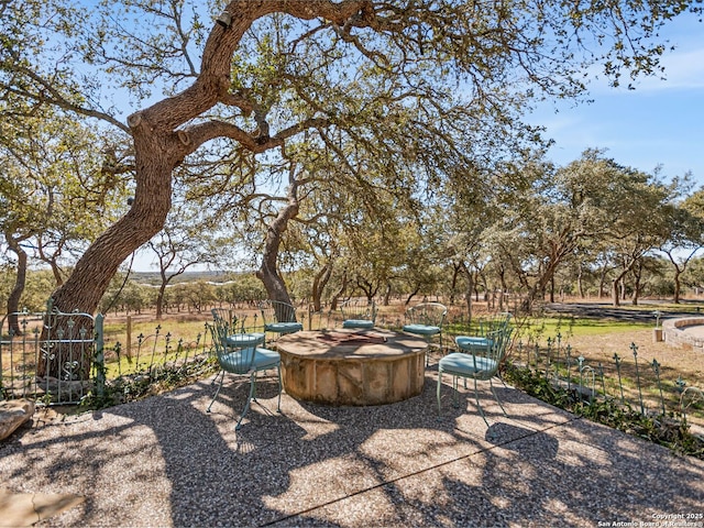 view of patio / terrace with an outdoor fire pit and fence