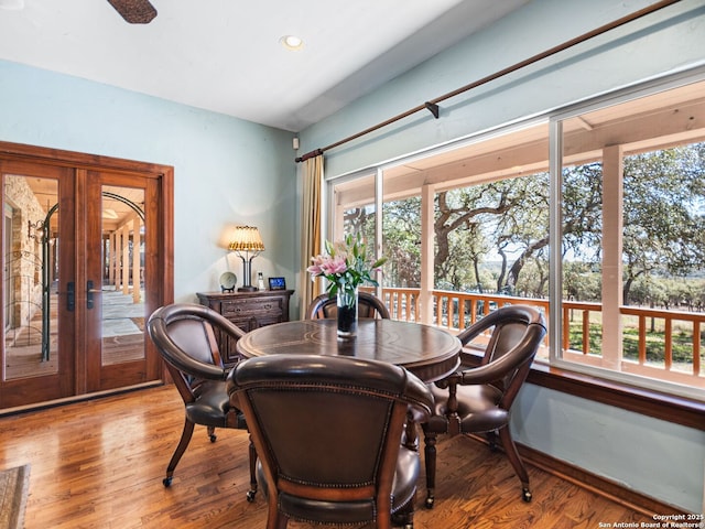 dining area featuring french doors, a healthy amount of sunlight, and wood finished floors