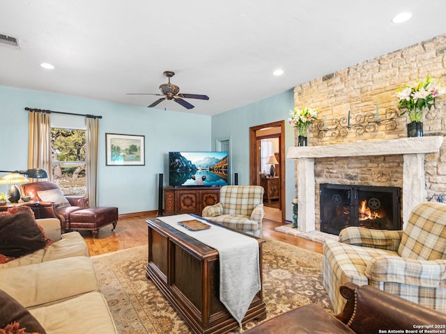 living area featuring wood finished floors, visible vents, a fireplace, recessed lighting, and ceiling fan