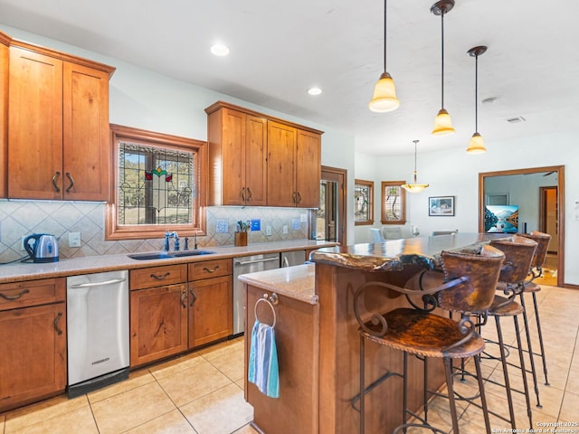 kitchen with a sink, a kitchen island, stainless steel dishwasher, and brown cabinetry