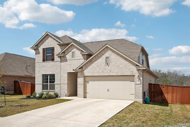 view of front facade with brick siding, driveway, a front yard, and fence