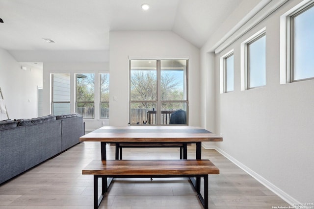 dining area featuring visible vents, baseboards, light wood-type flooring, lofted ceiling, and recessed lighting