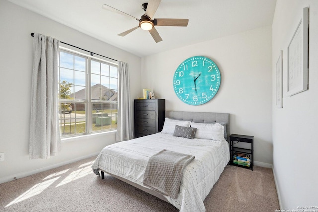 carpeted bedroom with baseboards and a ceiling fan