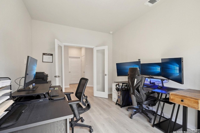 office area with visible vents, french doors, light wood-type flooring, and baseboards