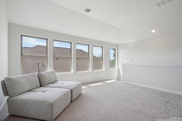 sitting room featuring visible vents, lofted ceiling, carpet, and baseboards