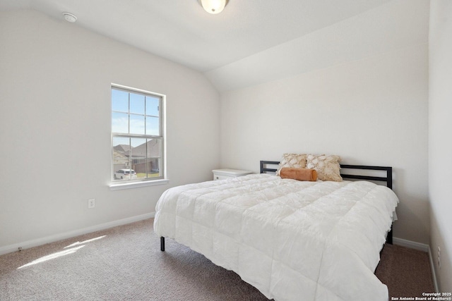 carpeted bedroom featuring baseboards and lofted ceiling