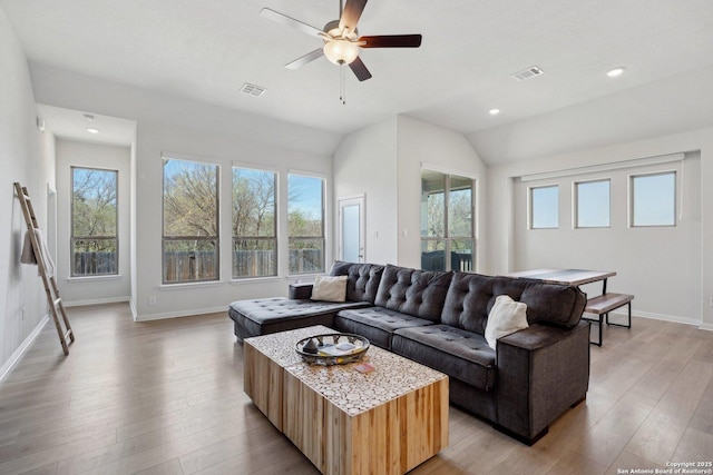 living area with ceiling fan, visible vents, baseboards, and light wood-style flooring