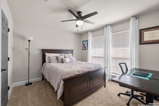 bedroom featuring light colored carpet, baseboards, and ceiling fan