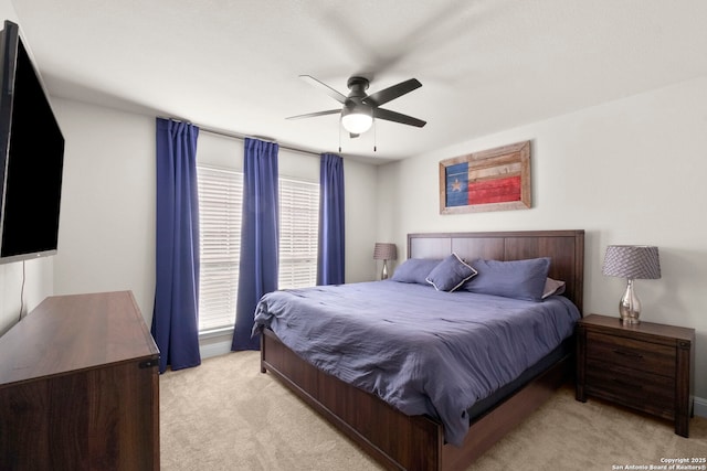 bedroom with light colored carpet and ceiling fan