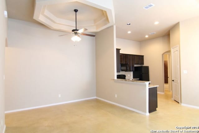 kitchen featuring visible vents, black appliances, arched walkways, light countertops, and ceiling fan