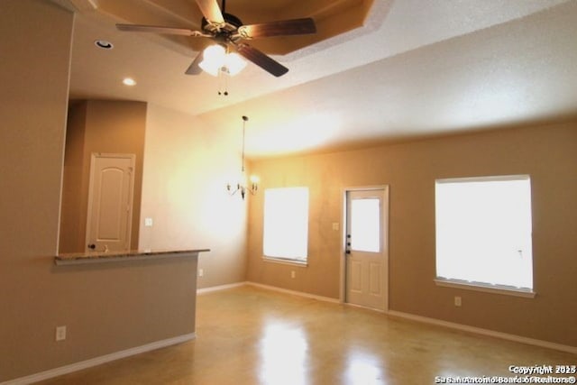 empty room featuring recessed lighting, ceiling fan with notable chandelier, and baseboards