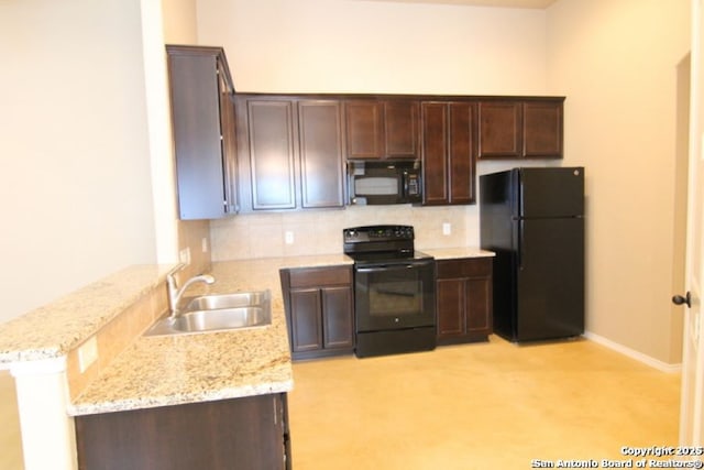 kitchen with a peninsula, a sink, black appliances, dark brown cabinetry, and backsplash