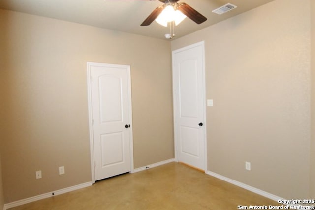 unfurnished room with a ceiling fan, visible vents, and baseboards