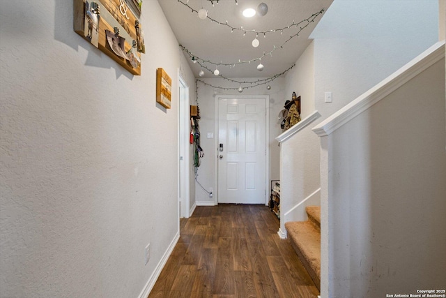 hall with stairway, baseboards, and wood finished floors