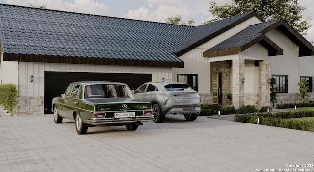 exterior space with stone siding, driveway, and a tile roof