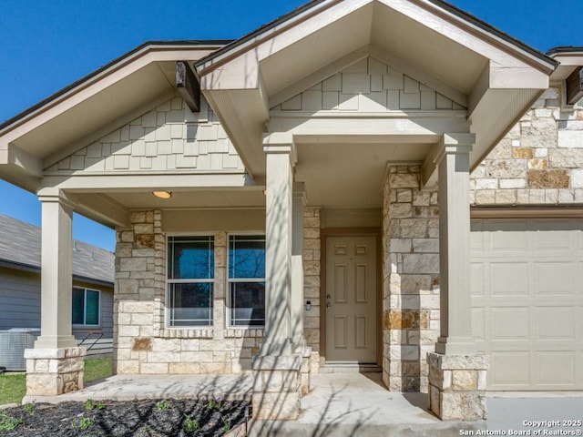 property entrance with stone siding, covered porch, and central air condition unit