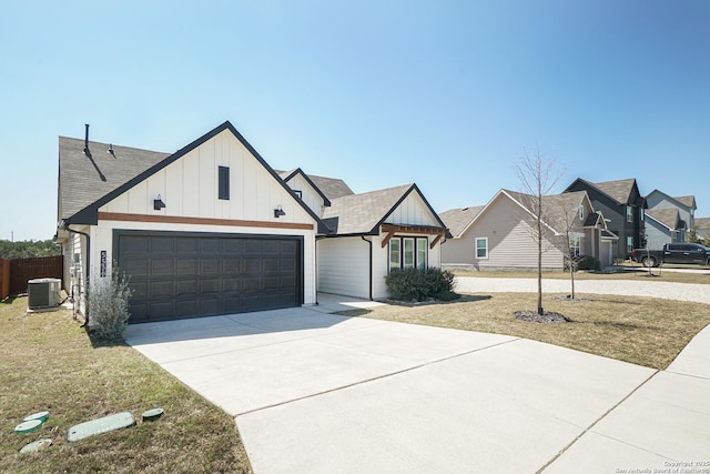 modern farmhouse featuring board and batten siding, a front lawn, central air condition unit, driveway, and an attached garage