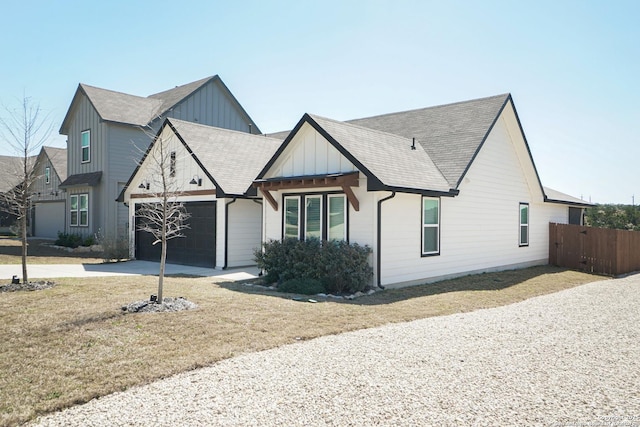 modern inspired farmhouse featuring board and batten siding, a shingled roof, fence, concrete driveway, and an attached garage