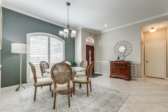 dining area featuring light tile patterned floors, crown molding, and an inviting chandelier