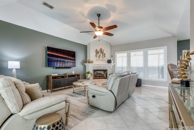 living area featuring visible vents, baseboards, light tile patterned floors, lofted ceiling, and ceiling fan