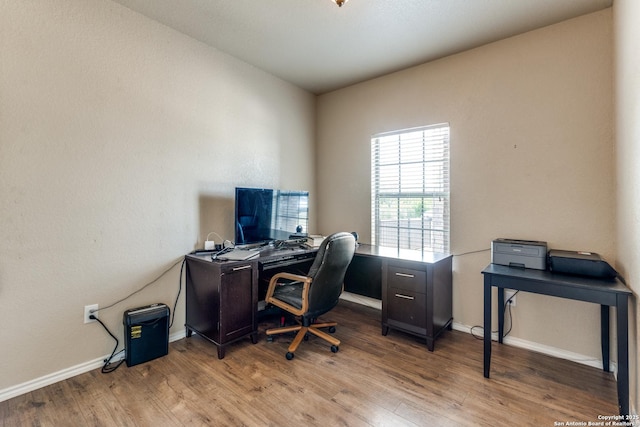 home office with wood finished floors and baseboards