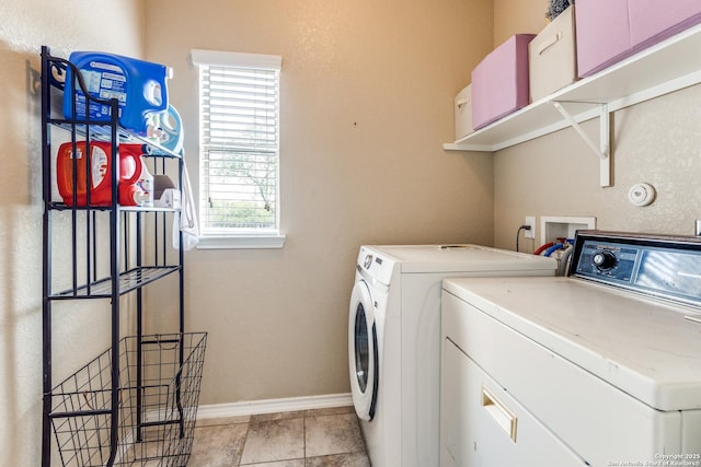 laundry room featuring washing machine and dryer, laundry area, and baseboards