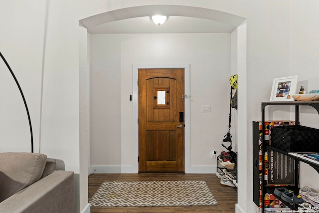 entrance foyer featuring baseboards and wood finished floors