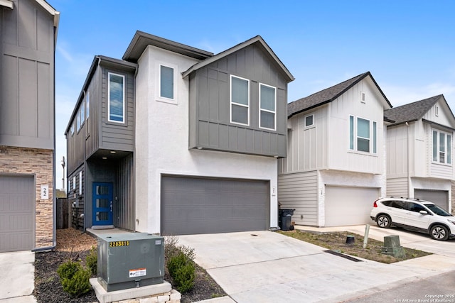 view of front of house featuring board and batten siding, concrete driveway, and a garage