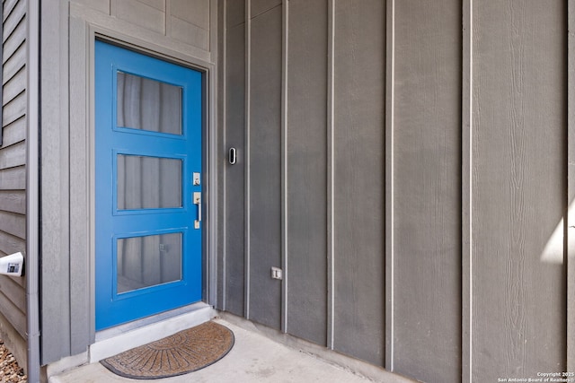 view of exterior entry featuring board and batten siding