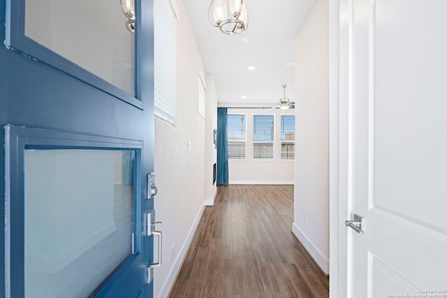 hall with recessed lighting, dark wood-style floors, and baseboards