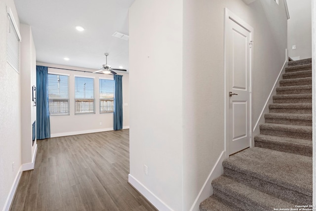 stairs featuring recessed lighting, wood finished floors, baseboards, and ceiling fan