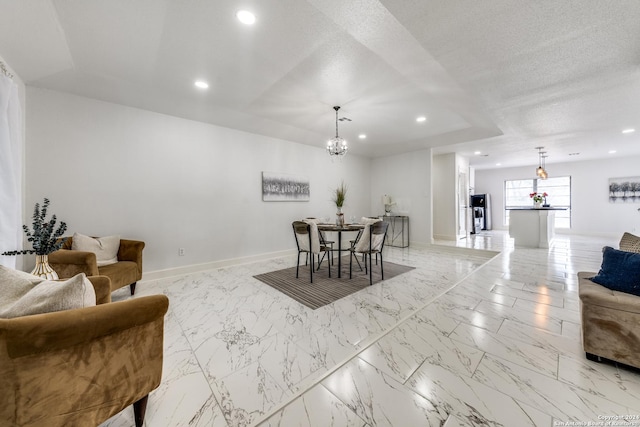 dining room with a notable chandelier, recessed lighting, a textured ceiling, and baseboards