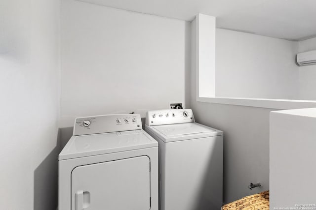 laundry room with washing machine and dryer, laundry area, and a wall unit AC