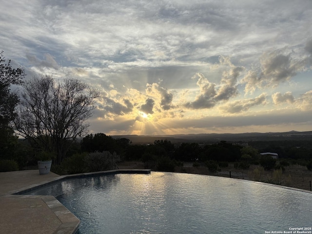 view of pool with an infinity pool