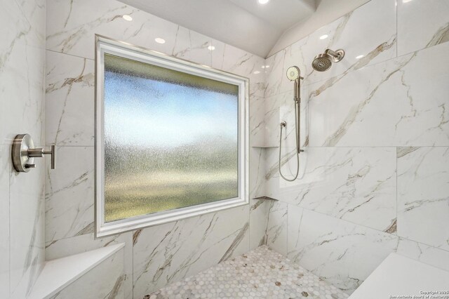 full bathroom with a marble finish shower