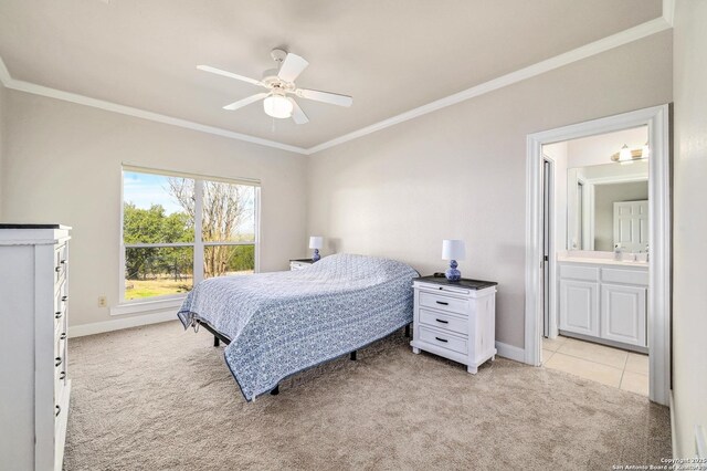 bedroom featuring light colored carpet, connected bathroom, crown molding, and baseboards