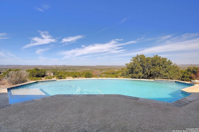 outdoor pool featuring a patio