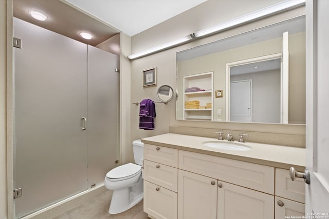 full bathroom with vanity, a shower stall, and toilet