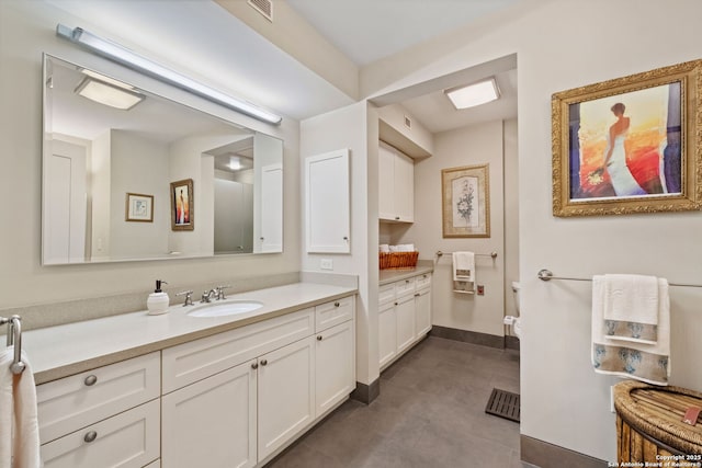 bathroom with visible vents, vanity, and baseboards