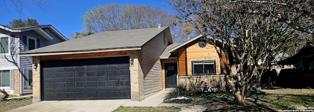 view of front of house featuring concrete driveway, brick siding, and a garage