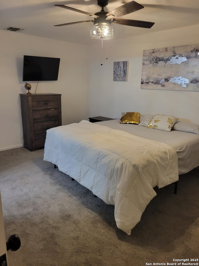 bedroom featuring visible vents, a ceiling fan, and carpet