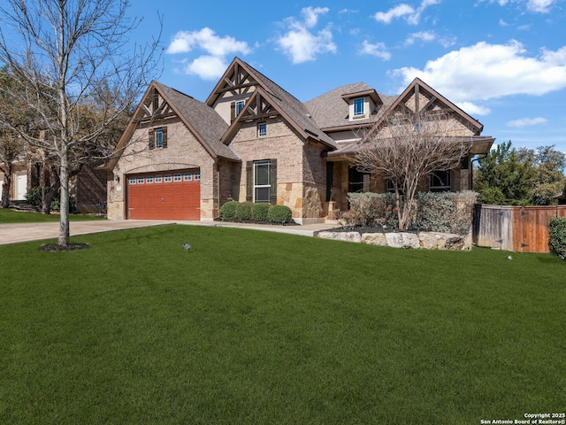 view of front of house with a front yard, a garage, fence, and stone siding