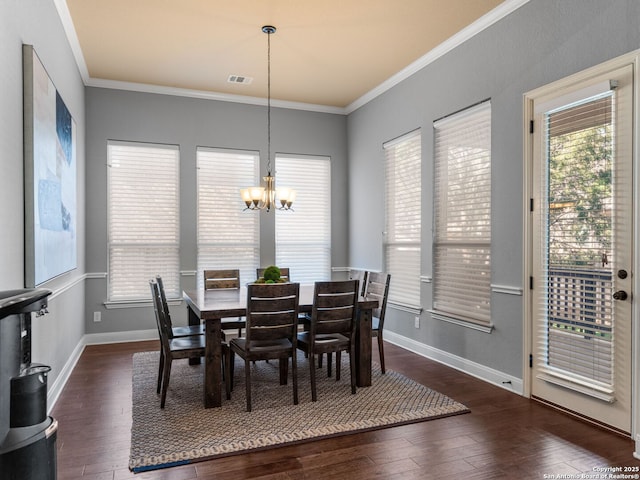 dining area with visible vents, ornamental molding, a wealth of natural light, hardwood / wood-style flooring, and a notable chandelier