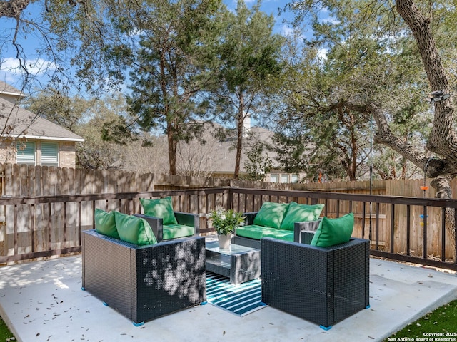 view of patio featuring an outdoor living space and a fenced backyard