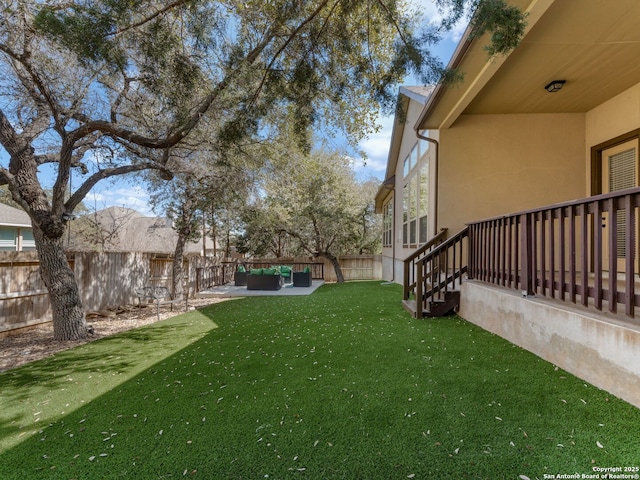 view of yard with outdoor lounge area, a patio, and a fenced backyard