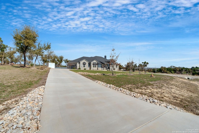 view of front of property with concrete driveway and a front yard