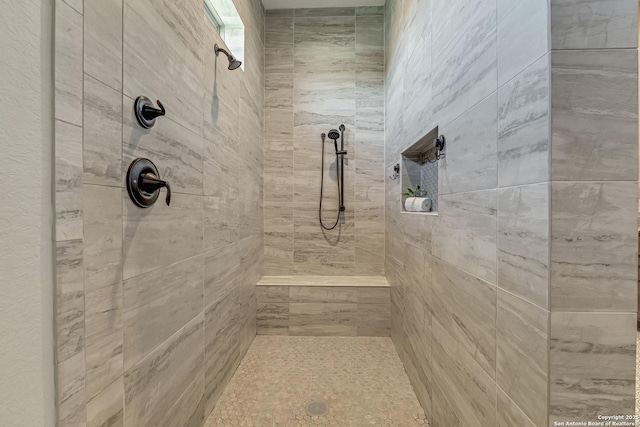 full bathroom featuring tiled shower