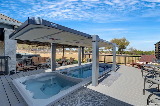 view of pool featuring a deck and an outdoor hot tub