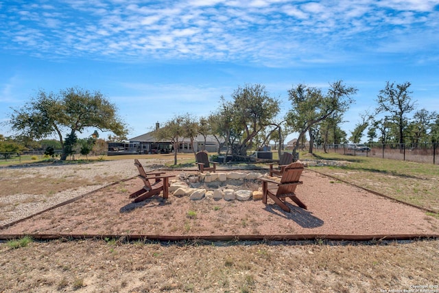 view of yard featuring a fire pit and fence